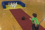 Children Playing Ten Pin Bowling in Gym