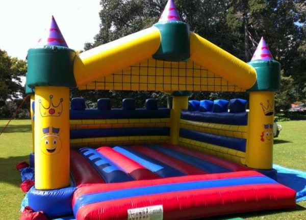 Yellow, Red and Blue Bouncy Castle Setup on Grass