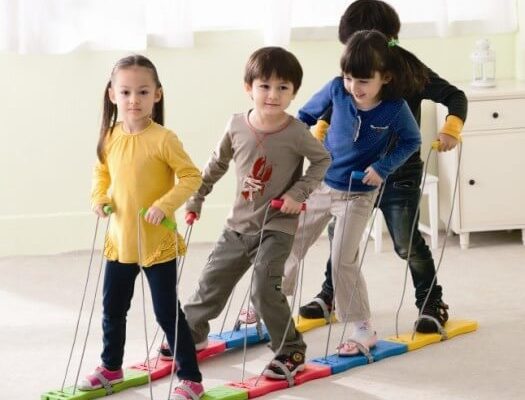 4 Children Using 4 Person Team Walker Inside