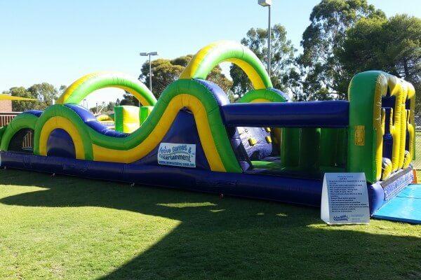 Side View of Inflatable Radical Run Obstacle Course Setup on Grass